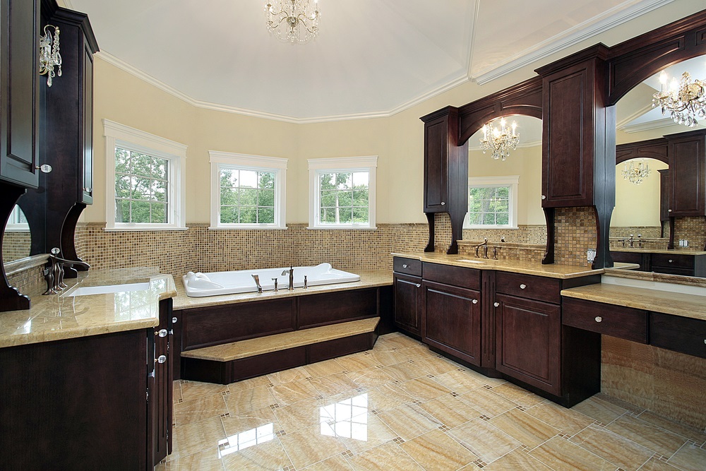 Luxury bathroom remodeling with dark wood cabinetry, built-in bathtub, and elegant tile flooring.